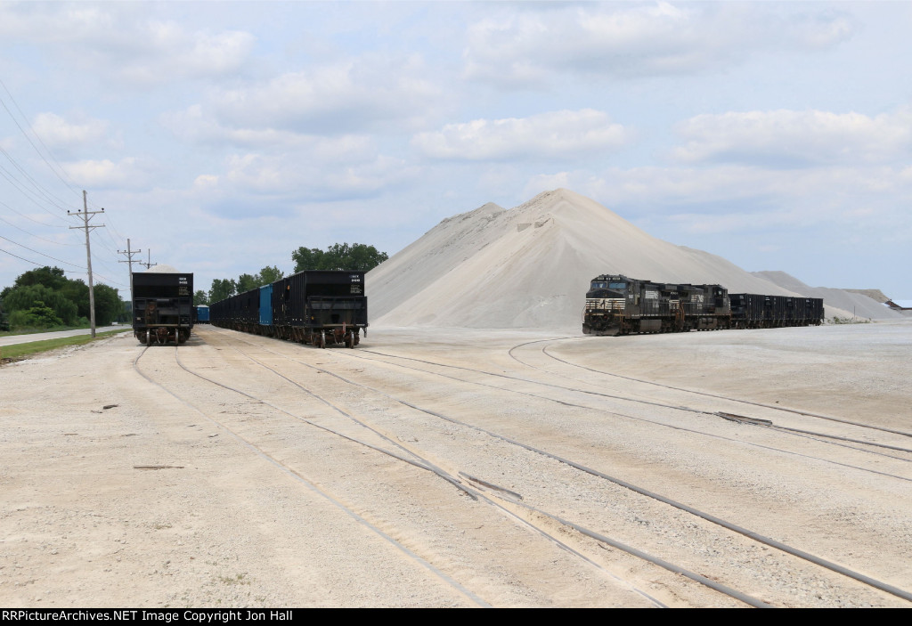 Stone empties and loads wait at the quarry